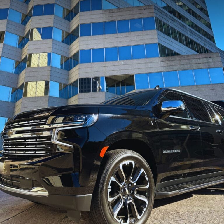 Black Chevrolet Suburban outside a glass office tower in Charlotte
