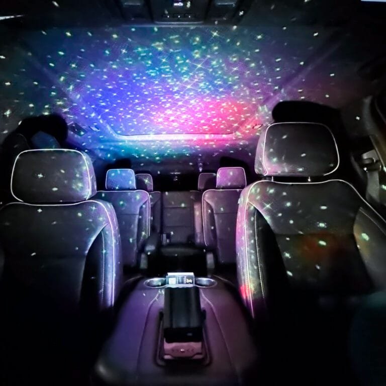 Starlight headliner and ambient lighting inside a black luxury SUV