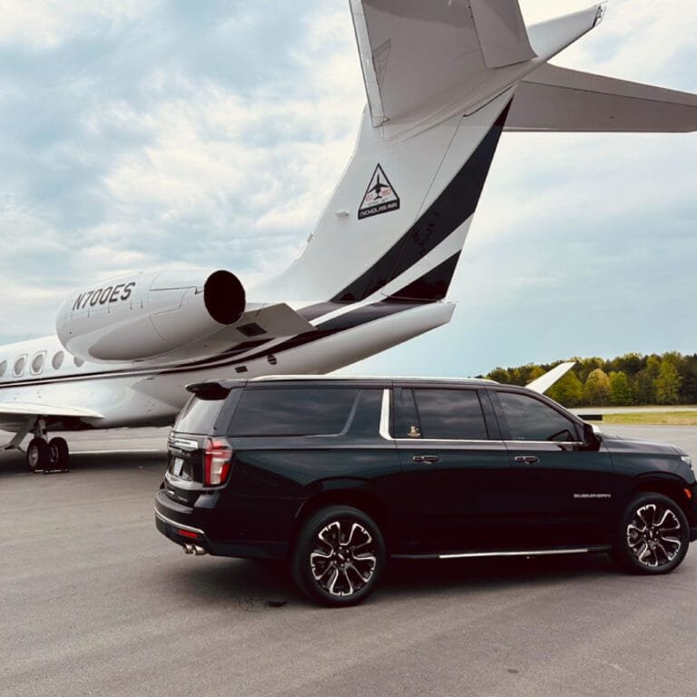Black SUV next to a private jet for an airport transfer