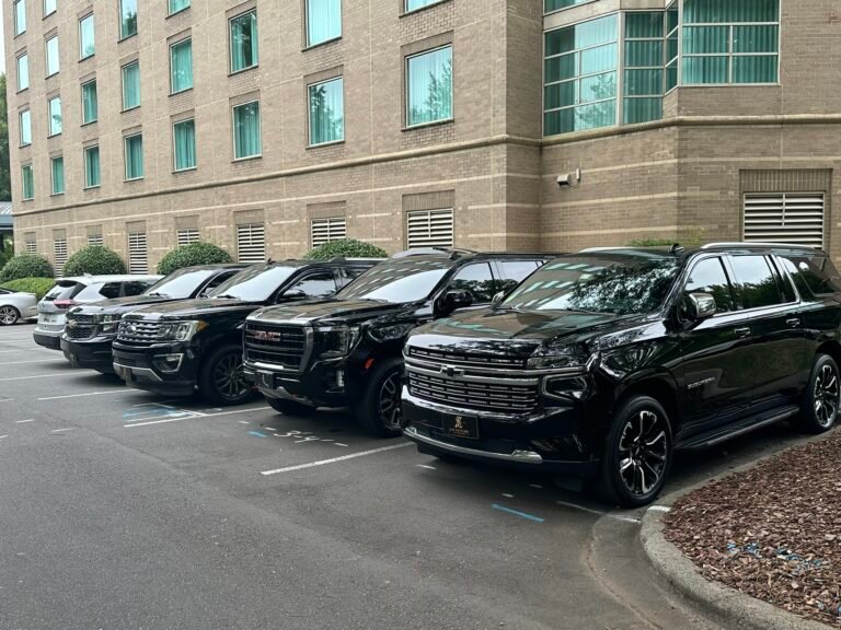 Row of black SUVs in a hotel parking lot