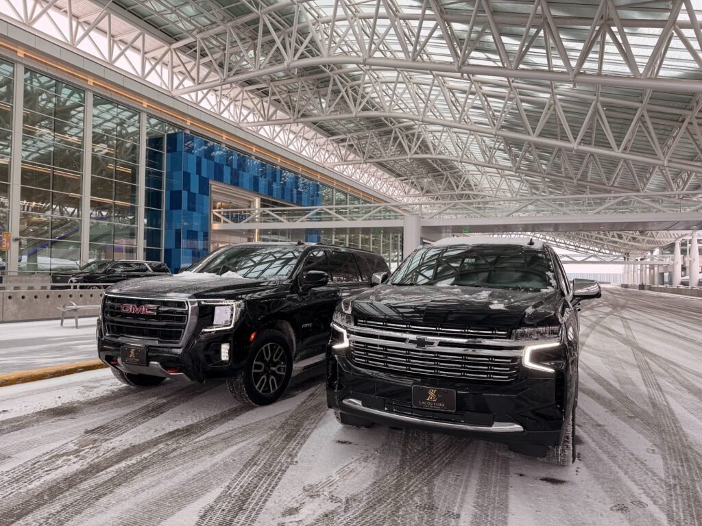 Black GMC SUVs ready for an airport transfer