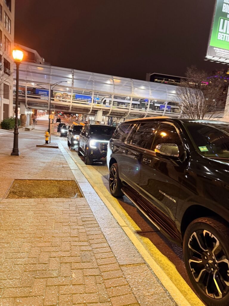 Black Chevrolet Suburban at an airport curbside pickup