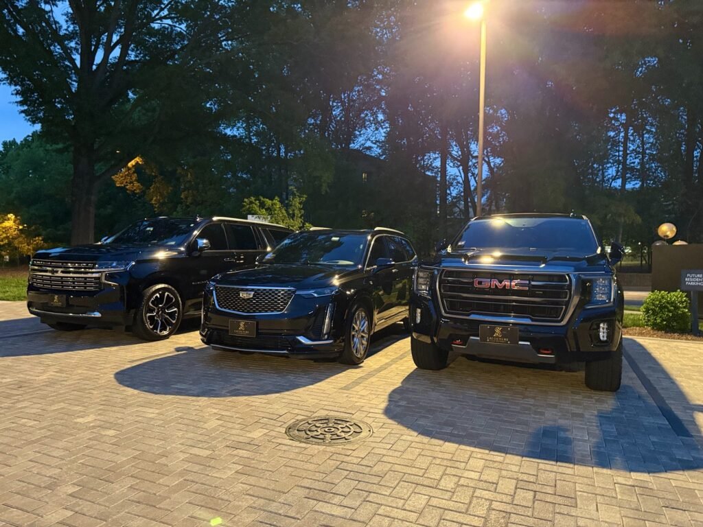 Lacouture Lux Services fleet of black vehicles in the evening