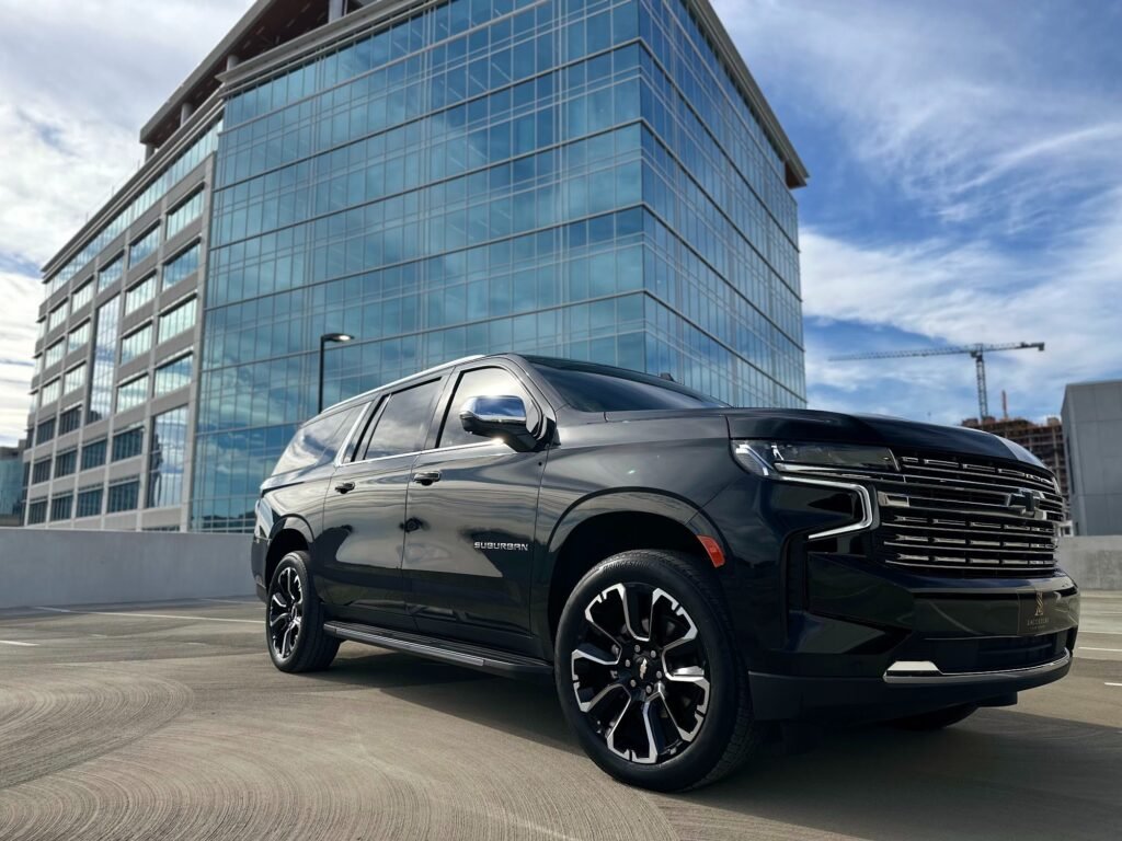 Black executive SUV beside a glass office tower in SouthPark, Charlotte